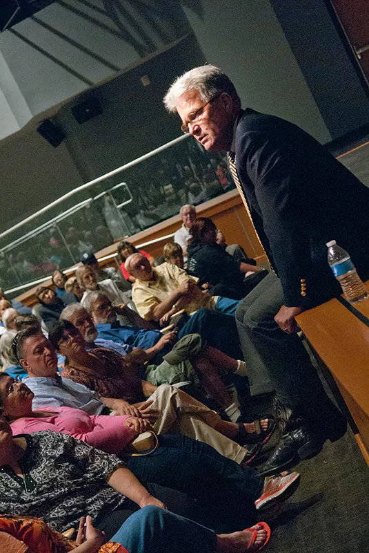 U.S. Senator Tom Coburn gets comfortable at the edge of the stage during a town hall meeting in the OCCC Visual and Performing Arts Center, Monday, 8-4-14. mh