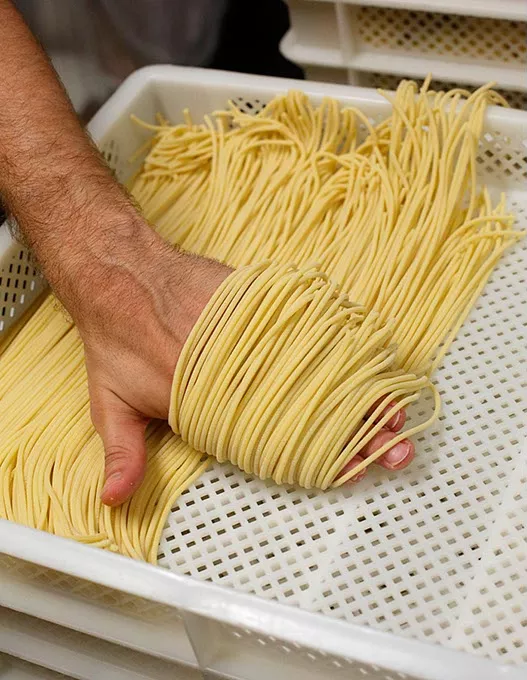 Chris Becker makes spaghetti for Della Terra Pasta at Urban Agrarian in Oklahoma City, Satuday, Aug 1, 2015. - GARETT FISBECK