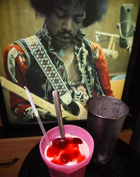 Strawberry milkshake in front of Jimi Hendrix photo, at Fat Elvus Diner in Yukon. mh
