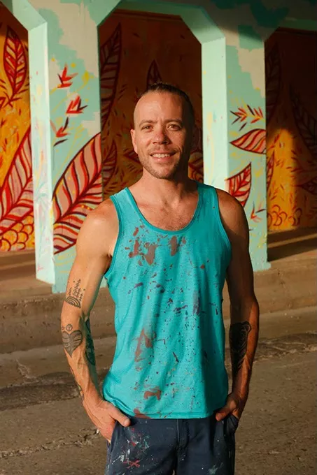 Jason Pawley' poses for a photo at his "Cultivation" mural in Oklahoma City, Thursday, July 2, 2015. - GARETT FISBECK