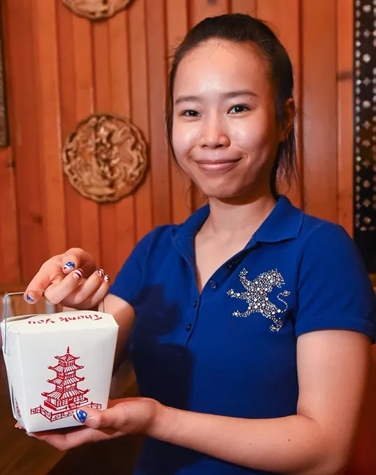 Ann Mao with Mandarin fried rice to go which comes in small, medium, or this, large size, at Mandarin Chinese & American Restaurant in Del City. mh