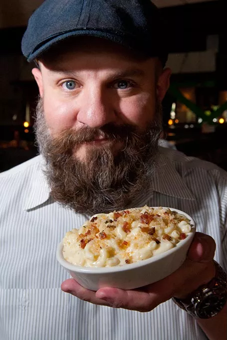 General Manager Tanner Fleming with Mac & Cheese at Whiskey Cake Kitchen & Bar. mh