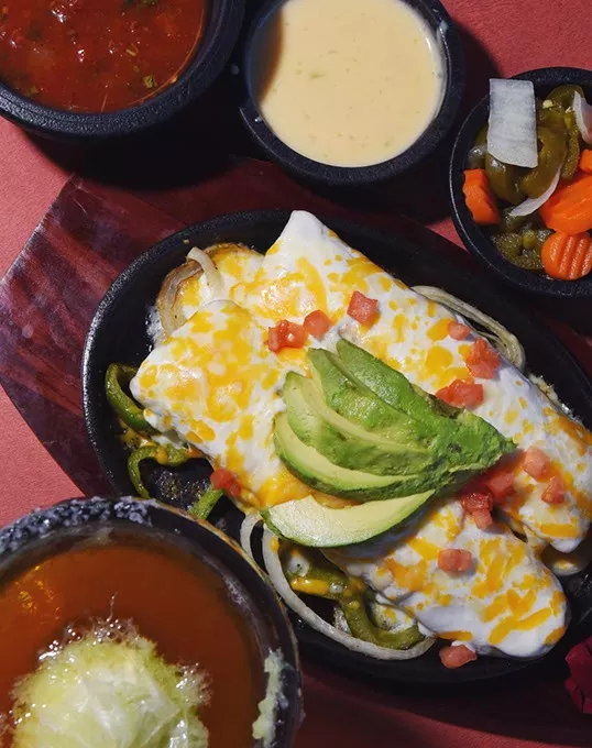 Tacate, sauces and Avocado Enchiladas at Wholly Guacamole Kitchen in Midwest City. mh