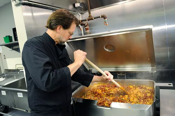 Chef Kurt Fleischfresser preps lunch at WestTown day shelter in Oklahoma City, Tuesday, March 24, 2014. - GARETT FISBECK