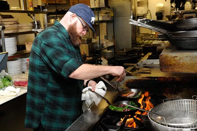 Chris McKenna, head chef, cooks at Packard's in Oklahoma City, Thursday, Dec. 24, 2015. - GARETT FISBECK