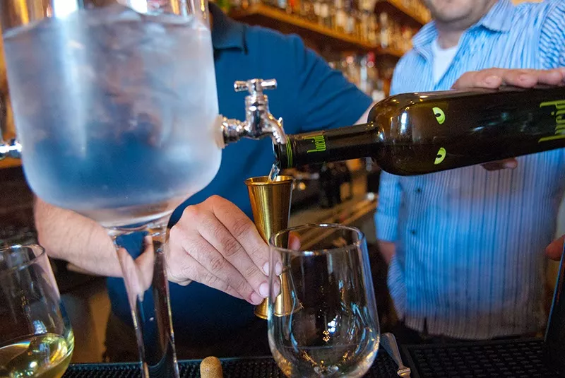 Chris Barrett, left, and Eric Corff prepare absinthe drinks by dripping chilled water over sugar cubes into glasses of Lucid Absinthe Supérieure at Ludivine. (Mark Hancock)
