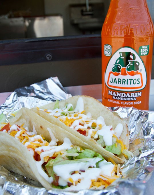 Discada tacos (meat lovers tacos) being served with a mandarin jarritos at Juan More Tacos food truck in Moore, Saturday, July 25, 2015. - KEATON DRAPER