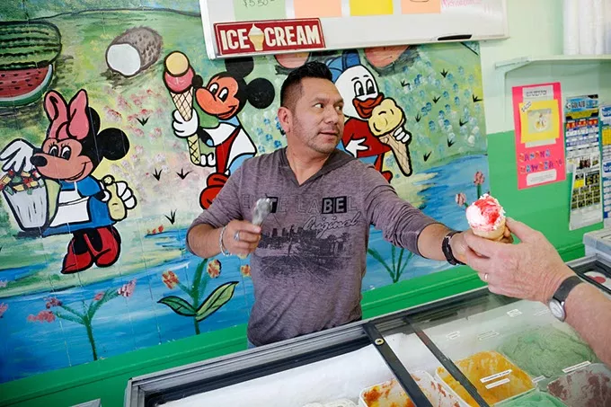 Nestor Garcia serves ice cream at his business in Oklahoma City, Thursday, April 2, 2015. - GARETT FISBECK