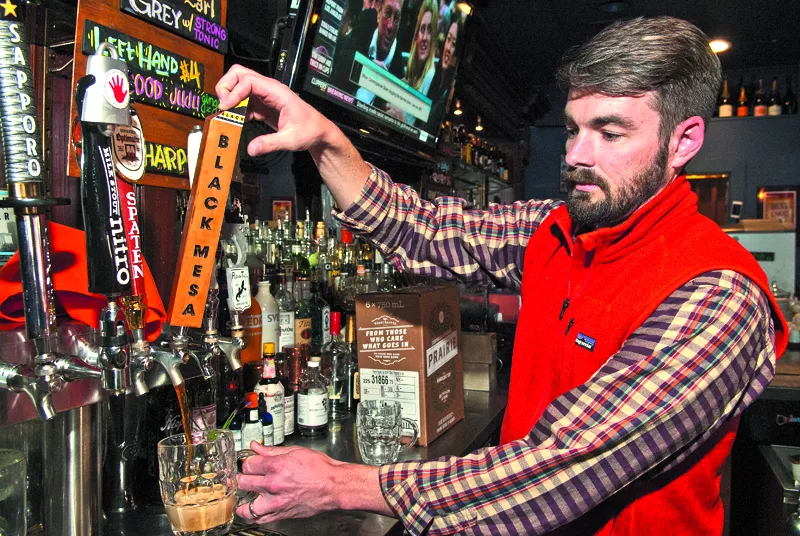 Brad Stumph, owner of Black Messa Brewing Company, draws his winning Endless Sky Bitter from at tap at Picasso Cafe. mh