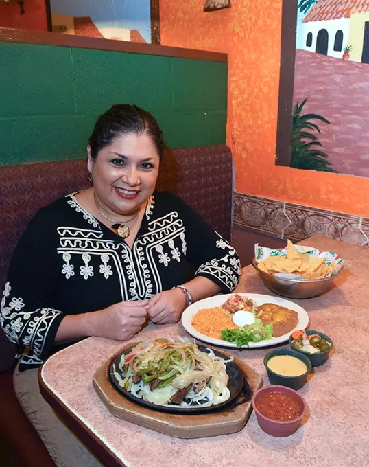 Sandra Rios is the owner of Carlito's Cafe in Yukon, shown with fajitas, 11-9-15. - MARK HANCOCK
