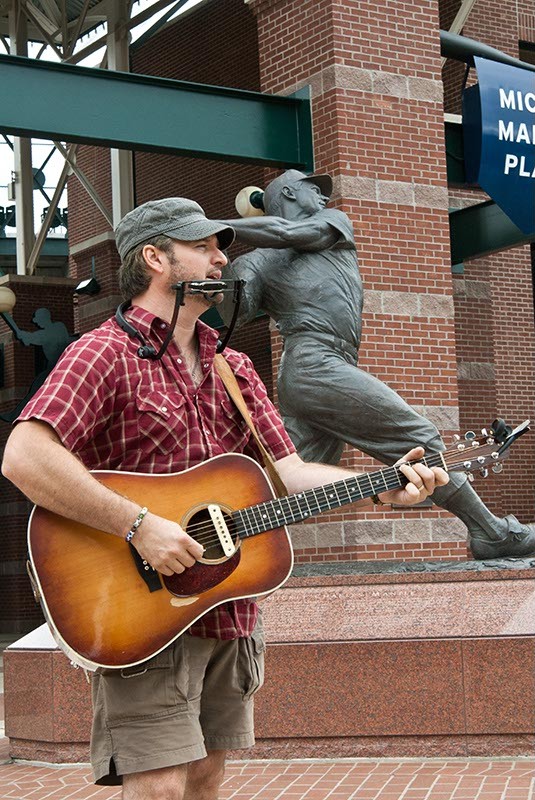 Out of the Box performer, Chad Slagle, plays near the Mickey Mantle statue at the Bricktown Ballpark, 7-19-14.  mh  mh