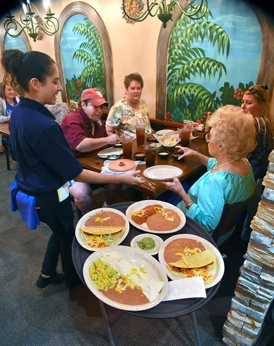 Waitress Laura Sanchez serves a family for lunch at the Del City Ted's Escondido, 9-23-15. - MARK HANCOCK