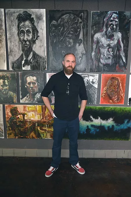 Artist J. Chris Johnson with his art showing at Brass Bell Studios. - MARK HANCOCK