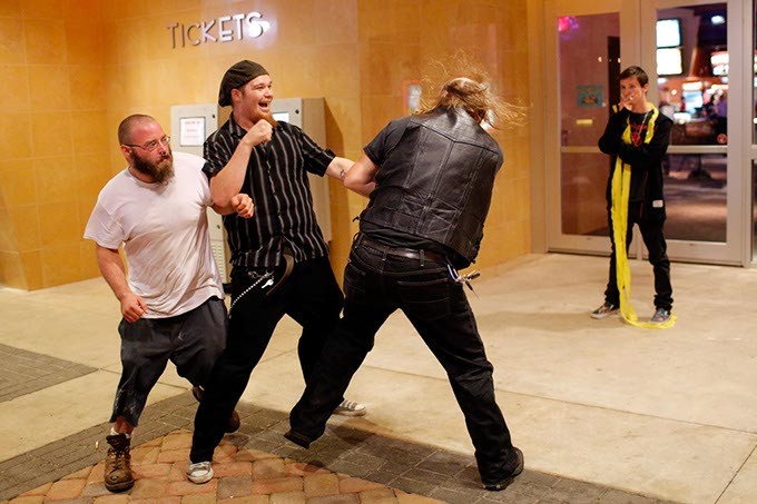 Member of opposing Satanic groups fight outside a movie theatre following a showing of "The Real Enemy" during the DeadCENTER Film Festival at Harkins Theatre in Oklahoma City, Thursday, June 11, 2015. - GARETT FISBECK