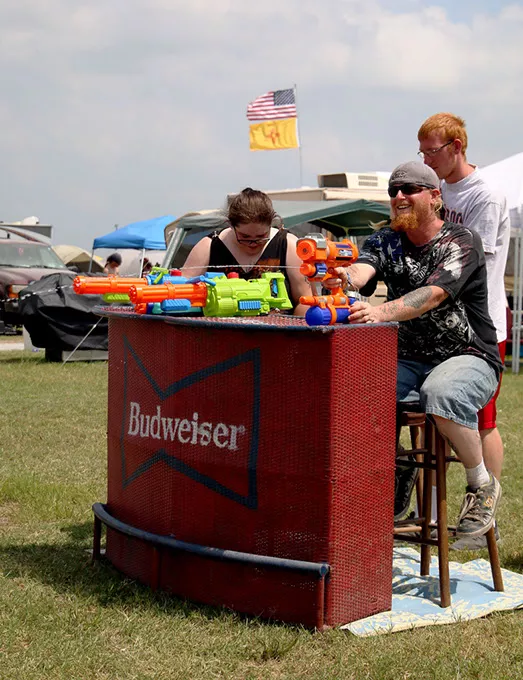 A group of campers spray down people walking to and from the campgrounds to cool them off at Rocklahoma in Pryor, Okla. on Staurday, May 27, 2017. (Cara Johnson).