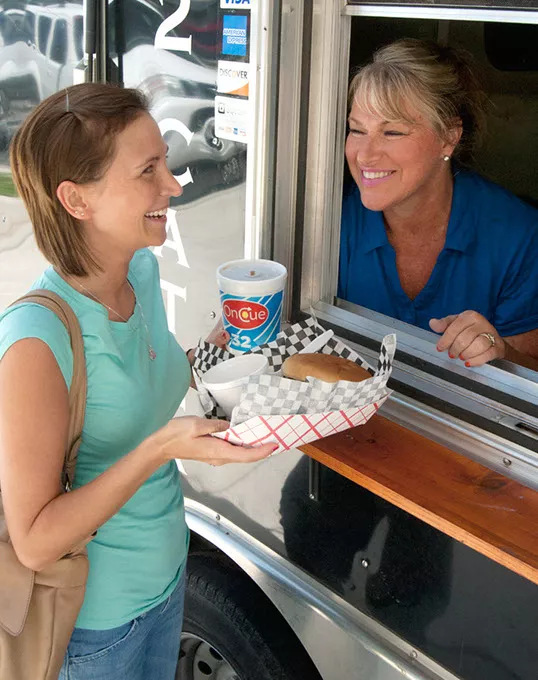 Melanie Wilson gets some lunch from Jan Clem at the window of Klemm's Smoke Haus, on location at Oklahoma Employee's Credid Union, 8-1-14. mh