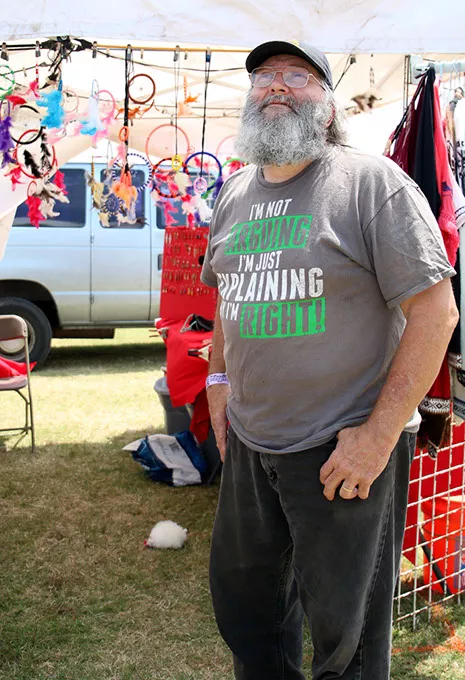 Vendor James Laird talks about the weather expected at Rocklahoma in Pryor, Okla. on Saturday, May 27, 2017. Concerts that night were canceled due to severe thunderstorms, wind, and flooding. (Cara Johnson).