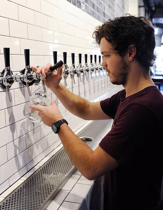Tyler Troy pours a drink at Oak and Ore in Oklahoma City, Monday, Nov. 30, 2015. - GARETT FISBECK