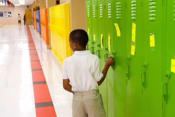 A student gets into his locker at F.D. Moon Elementary School. mh