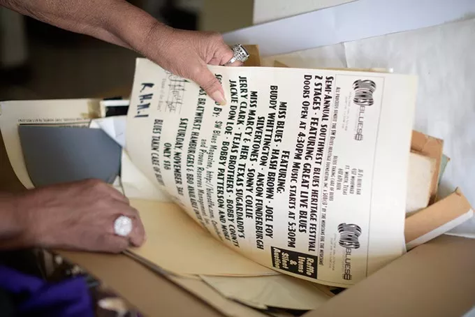 Miss Blues digs through old posters and photographs at her home in Oklahoma City, Tuesday, March 14, 2017. - GARETT FISBECK