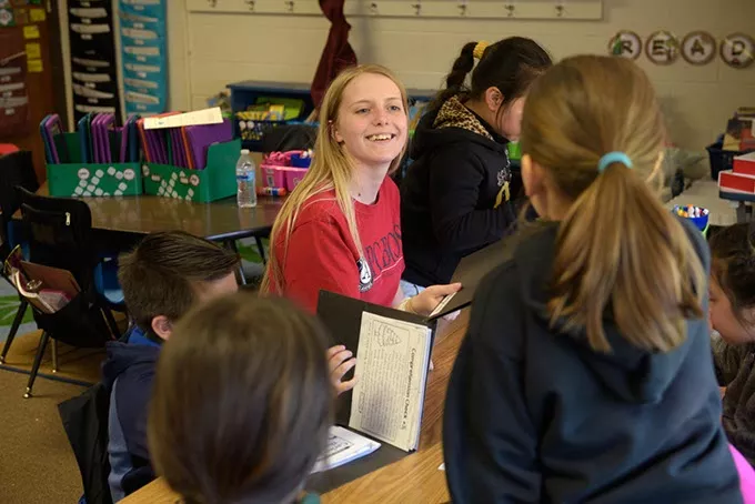 Abby Shelley, Americorps volunteer, works with children during an afterschool program at Hilldale Elementary, Thursday, April 6, 2017. - GARETT FISBECK
