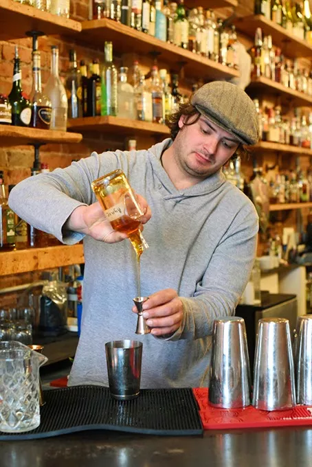 Colby Poulin makes a cocktail at Ludivine, Monday, April 11, 2016. - GARETT FISBECK