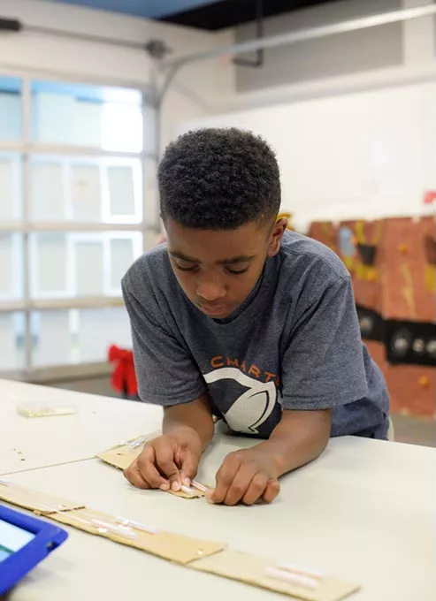 Mason Currin-Moore builds a prototype of a robotic arm during an Odyssey of the Mind practice at John Rex Elementary, Thursday, April 20, 2017. - GARETT FISBECK