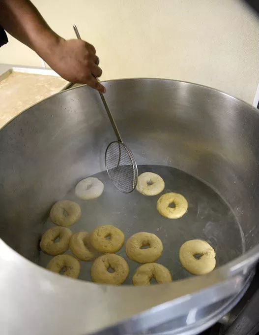 Josey Sommers, of Backyard Bounty Bakery, boils bagels, Friday, Aug. 12, 2016. - GARETT FISBECK