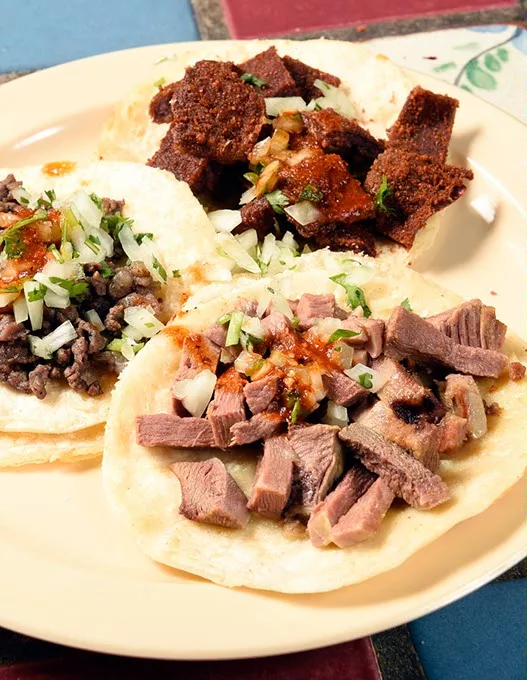 Azada, Milaneza, and Lengua tacos at Carnitas Michoacan in Edmond, Thursday, May 26, 2016. - GARETT FISBECK