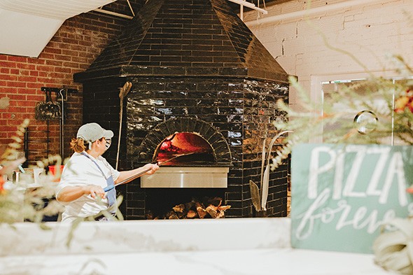 The wood-fired oven at The Hall’s Pizza Kitchen reaches temperatures in excess of 800 degrees Fahrenheit. - ALEXA ACE