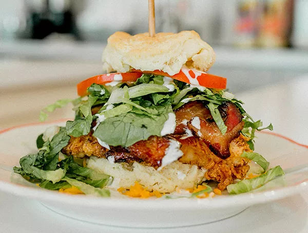 A club sandwich with fried chicken, lettuce, tomato and bacon from HunnyBunny Biscuit Co. - ALEXA ACE