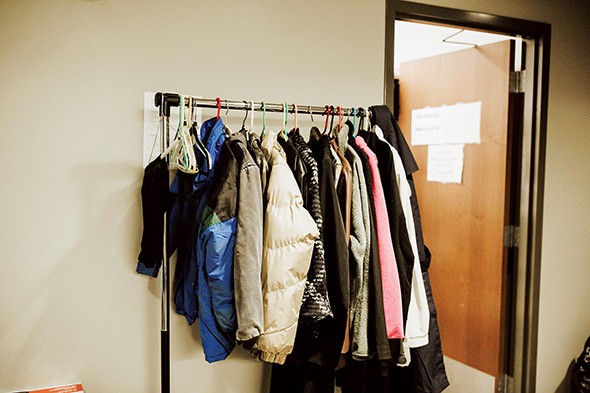 Coats hang on a rack in a hall at The Homeless Alliance of Oklahoma City. - ALEXA ACE