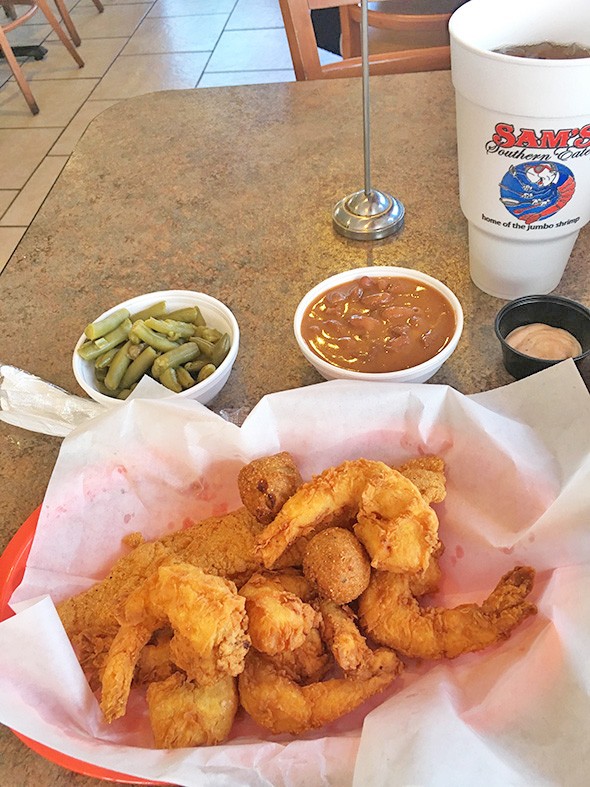 Shrimp lives up to the restaurant’s claim of “home of the jumbo shrimp,” along with fish and sides of green beans and red beans and rice. - JACOB THREADGILL