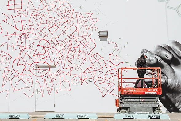 Street artist Jeks lays down the foundation for his second mural on the southern wall of BCC Collective. - ALEXA ACE