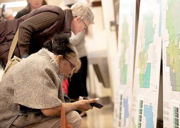 Community members examine the final district path map after the final recommendation was made Feb. 21. - MIGUEL RIOS