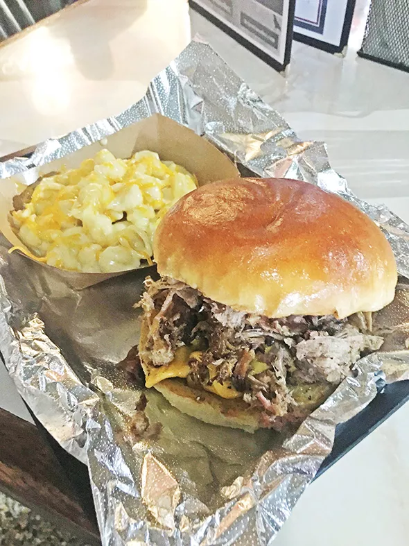 The Frank-N-Bill sandwich with smoked Angus - burger topped with pulled pork and a side of - seven-cheese mac - JACOB THREADGILL