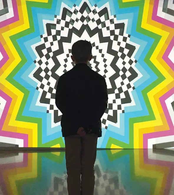 A young visitor is mesmerized by Daniel Sutliff’s video animation in The Experience. - AHHA / PROVIDED