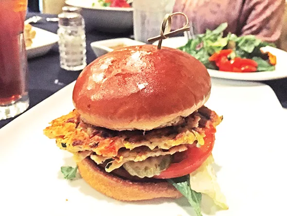 The veggie burger features two patties with a - hummus base and sauteed vegetables. - JACOB THREADGILL