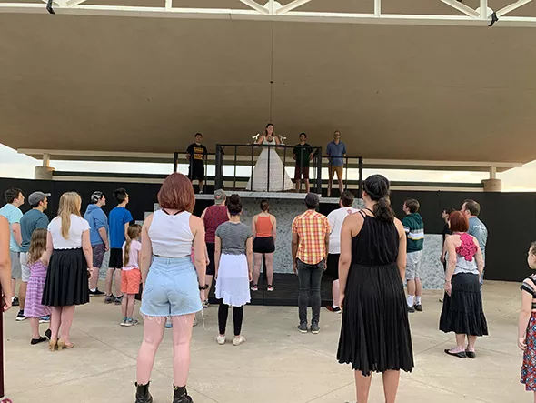 Upstage Theatre artistic director Jenny Rottmayer addresses the crowd as Eva Perón in a rehearsal for Evita. - PROVIDED