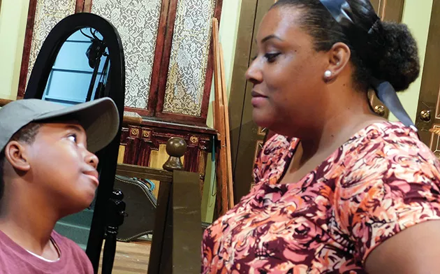 Myles Currin-Moore (Travis Younger) and Nykezia Giles (Ruth Younger) share a moment in A Raisin in the Sun.