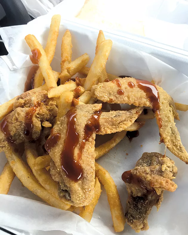 Chicken wings are lightly battered and finished with lemon pepper before the addition of mild sauce. - JACOB THREADGILL