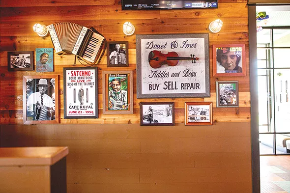 Blues and jazz artifacts line the wall at Razzoo’s Cajun Cafe in Oklahoma City. - ALEXA ACE