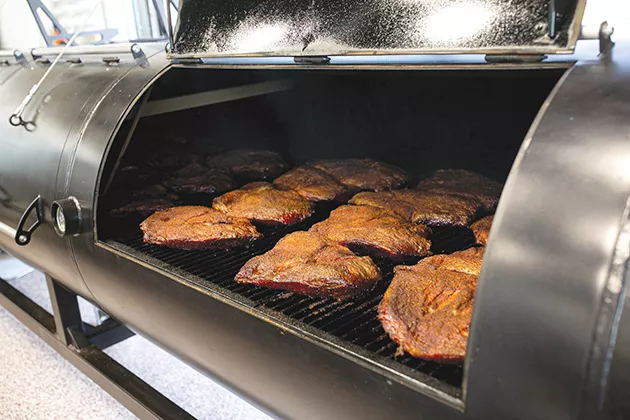 Brisket in the smoker at Clark Crew BBQ - ALEXA ACE