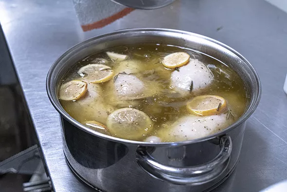 Vegetables and chicken are baked in a large pot or Dutch oven for two and a half hours. - PHILLIP DANNER