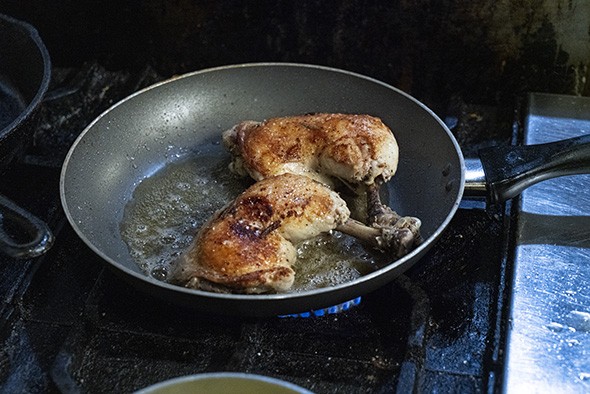 The chicken is browned in a saute pan after being baked. - PHILLIP DANNER
