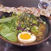 A Noodee bowl with ramen, grilled pork and pork broth. A Noodee bowl with ramen, grilled pork and pork broth.