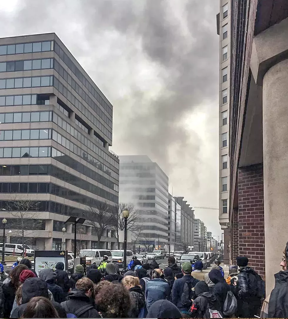 Smoke from a burning limousine as seen hours after mass arrests on Jan. 20. - PHOTO BY AARON CANTÚ