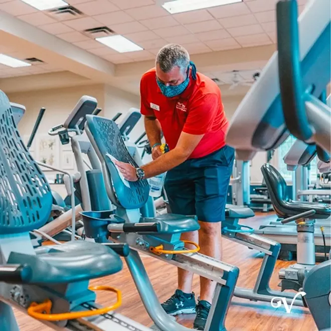 A worker in the Villages cleans exercise equipment on June 1 - PHOTO VIA THE VILLAGES/FACEBOOK