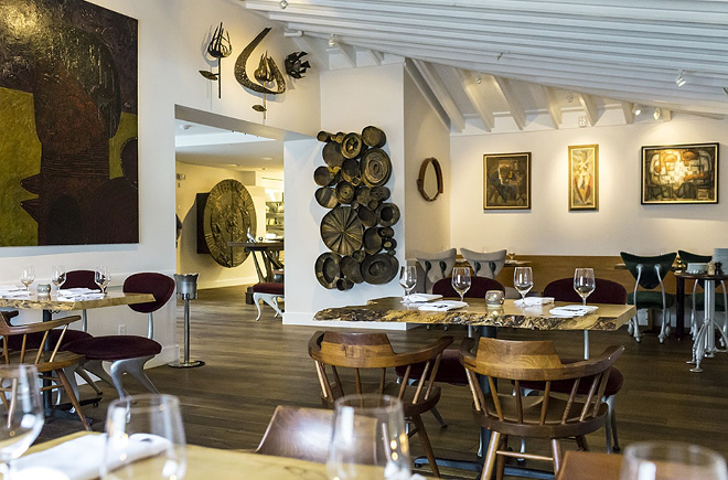 The dining room at 1921 by Norman Van Aken is full of eclectic art collected by the chef. - ROB BARTLETT