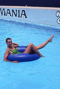 Woman riding inner tube at the Water Mania theme park in Kissimmee, Florida. 1989.